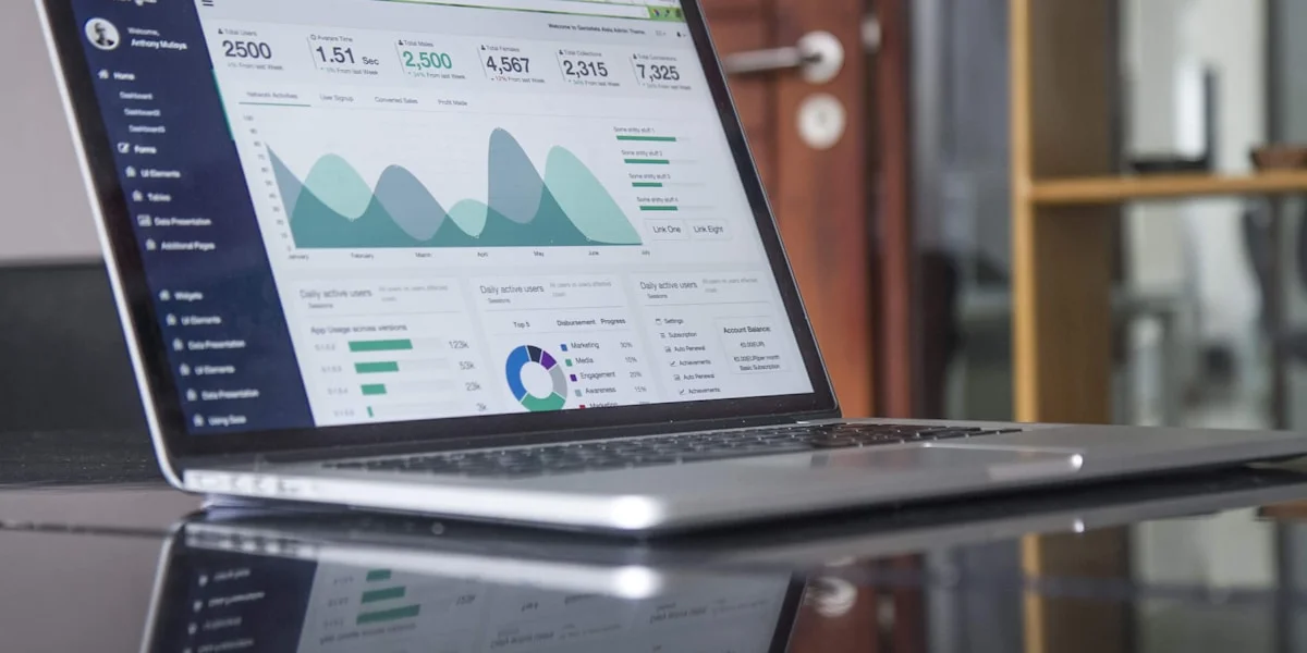 Laptop showing analytics dashboard with marketing strategy notes