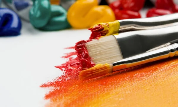 Artist painting colorful artwork on canvas