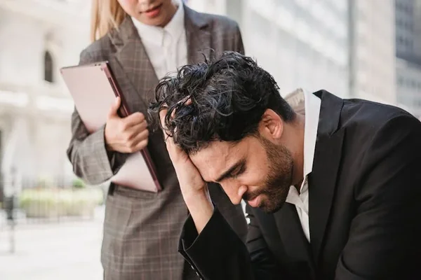 Worried man with attorney outside courthouse